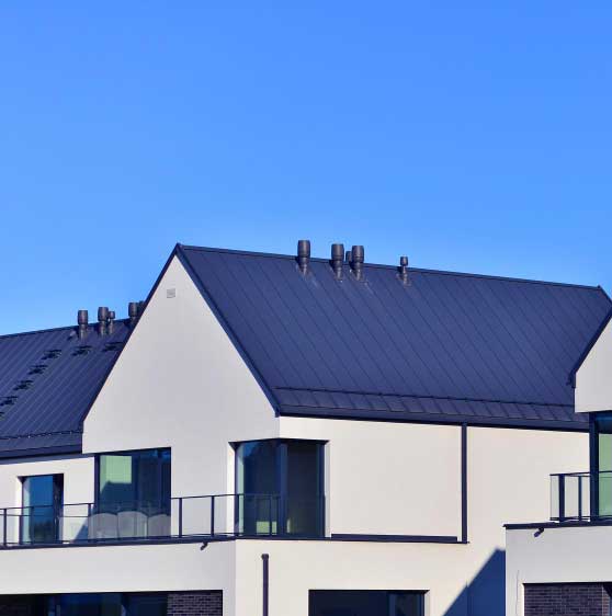 Close-up of a modern residential building with a standing seam metal roof and clean facade, highlighting durable materials and professional Roofing Fort Pierce, FL services.