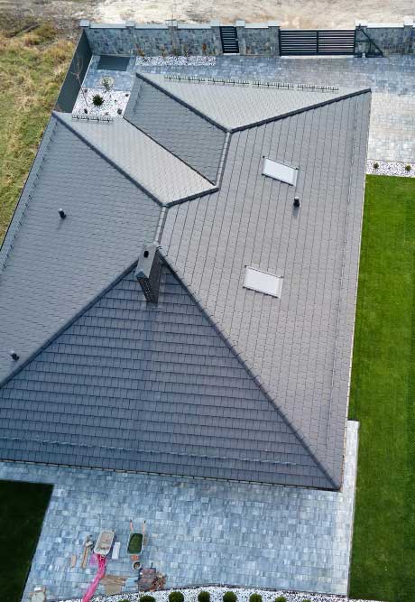 Top-down aerial view of a residential property with a modern shingle roof, skylights, and clean lines, showcasing quality workmanship and dependable Roof Repair Port St Lucie, FL services.