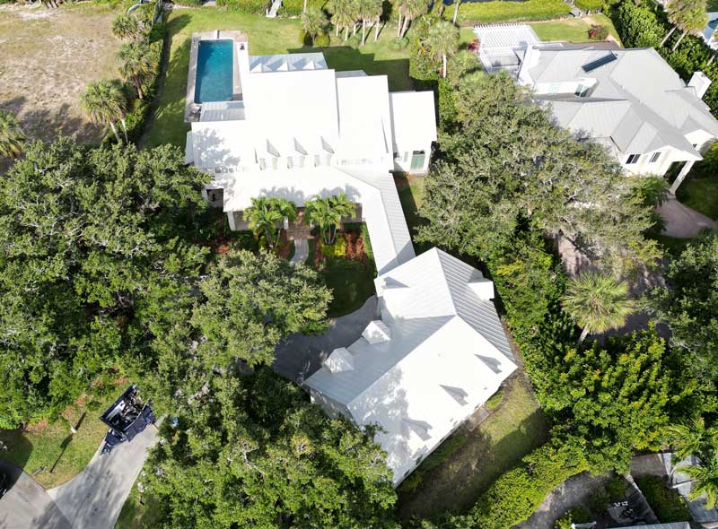 Drone aerial view of oceanfront homes with metal roofing systems, highlighting coastal durability, expert installation, and trusted Roof Repair Indian River County, FL services.
