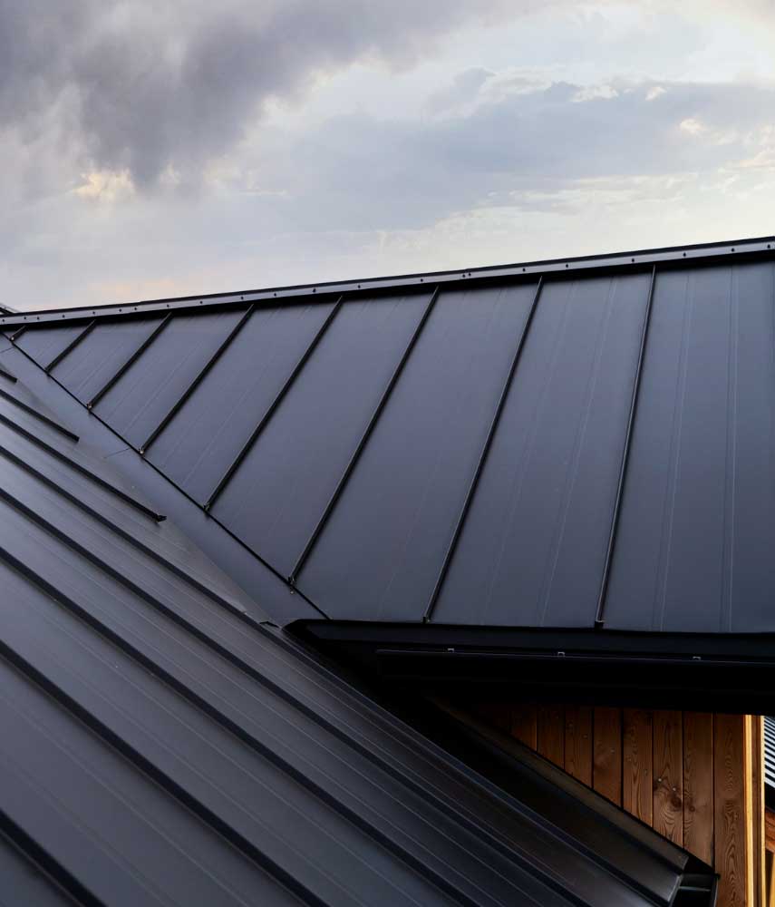 Aerial view of a residential property with a newly installed metal roof, clean seams, and professional workmanship, highlighting durable construction and trusted Local Roof Repair Services Near Me solutions.